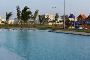 a swimming pool in a park with a playground at Awali Villa B9 in Kilifi
