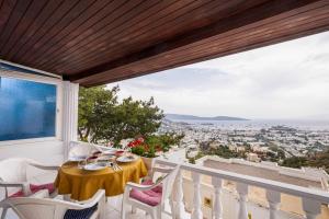 a table on a balcony with a view of the city at BODRUM BURCU VILLA , Magnificent Sea View, Cozy, Free Otopark, Free Wifi in Bodrum City
