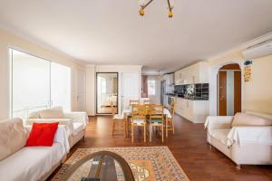 a living room with two white couches and a table at BODRUM BURCU VILLA , Magnificent Sea View, Cozy, Free Otopark, Free Wifi in Bodrum City