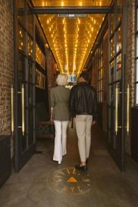 a man and a woman walking down a hallway at CIVILIAN Hotel in New York