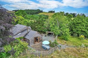 an overhead view of a house in the woods at Finest Retreats - The Dairyhouse in Church Stoke