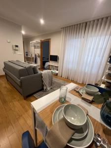 a living room with a couch and a table at The Blue Flat Vigo - A ESTRENAR - Apartamento Boutique Deluxe - Centro ciudad in Vigo