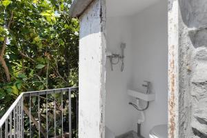 a bathroom with a sink and a toilet on a balcony at Schiara in Campiglia
