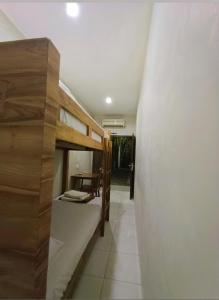 a hallway with two bunk beds in a room at Naturela in Uluwatu