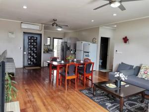 a living room with a table and a couch at Master Bedroom in Shared Cozy River View Pool Apartment in Nadi