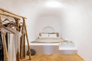 a bedroom with a bed in a white room at Caval II in Fira