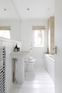 a white bathroom with a sink and a toilet at Charming 1 bedroom apartment in Rottingdean in Rottingdean