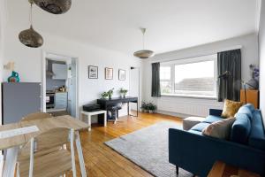 a living room with a blue couch and a table at Charming 1 bedroom apartment in Rottingdean in Rottingdean