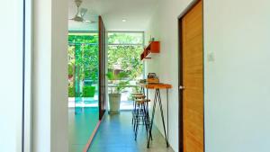 a hallway with a table and chairs in a house at MAR24 Koh Tao Hotel in Koh Tao