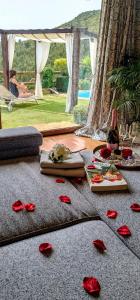 um quarto com rosas no chão e uma garrafa de vinho em Love Story - Lareira, Sauna & Piscina em Arcos de Valdevez
