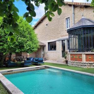 a swimming pool in front of a house at Grande maison Brocante avec piscine proche centre in Beaune