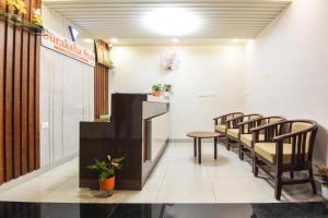 a waiting room with a table and chairs at Suraksha Stay Whitefield Hotel in Bangalore