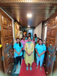 a group of people standing in a hallway at WhiteHouse Home stay by Oxystays in Alibaug