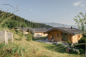 a group of wooden buildings on a hill at Hygna Chalets in Reith im Alpbachtal