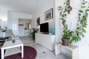 a living room with a tv on a white cabinet at Apartamento Encantador vista Mar in Fuengirola