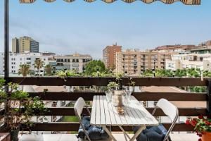 a table on a balcony with a view of a city at Apartamento Encantador vista Mar in Fuengirola