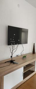 a living room with a table with a television on a wall at Markos Towers Apartments in Prilep