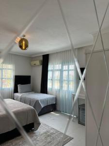 Ένα ή περισσότερα κρεβάτια σε δωμάτιο στο Datca house butik otel