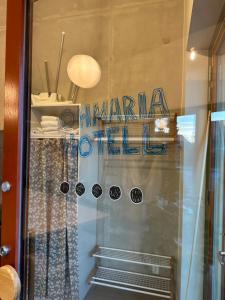 a window of a store with a sign on it at Ohmaria Hotell, del av Ohboy Hotell in Höllviken