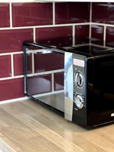 a black toaster oven sitting on top of a counter at Wi-Fi, 2 bathroom, 2 bedroom, sleeps 4-8 in Birmingham