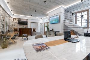 a living room with a laptop on a table at The Well Parga in Parga