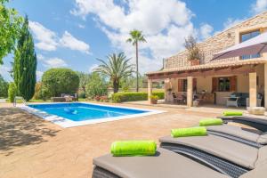 a villa with a swimming pool and a house at Finca Miralles in Búger
