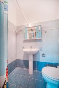 a bathroom with a sink and a toilet at Mirror Beach Ksamil - Vila Zervo in Sarandë