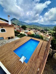 a swimming pool on the roof of a house at VILLA CHRYSANTHOS in Ágios Matthaíos