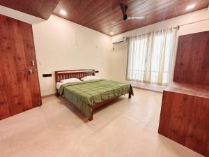 a bedroom with a bed and a large window at VIDHI VILLA -Besides Valley View 360 with Luxurious Swimming pool & AC in Mahabaleshwar