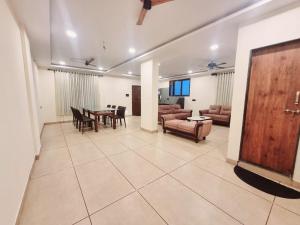 a living room with a couch and a table at VIDHI VILLA -Besides Valley View 360 with Luxurious Swimming pool & AC in Mahabaleshwar