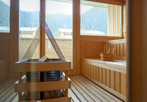 a room with a hammock in a room with windows at Chalet Resort Montafon I - Chalets & Chalet-Apartments in Sankt Gallenkirch