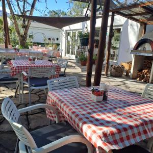 a table and chairs with a red and white checkered table cloth at Fiore Guest Accommodation in Greyton