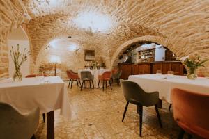 restauracja ze stołami i krzesłami w kamiennej sali w obiekcie Dwór Zbożenna w mieście Przysucha