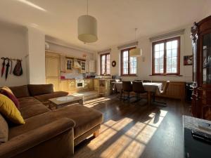 a living room with a couch and a table at Gael Stary Rynek 1 in Elblag