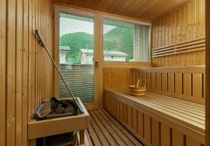 a inside of a sauna with a mop in it at Chalet-Resort Montafon in Sankt Gallenkirch