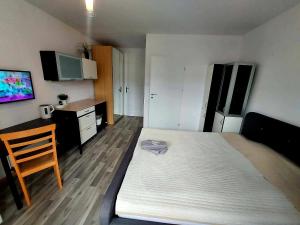 a bedroom with a bed and a desk and a television at CitySOPOT-Centrum-Dąbrowskiego in Sopot