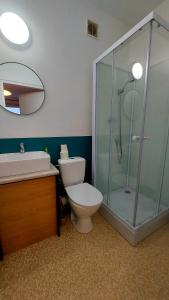 a bathroom with a toilet and a glass shower at CitySOPOT-Centrum-Dąbrowskiego in Sopot