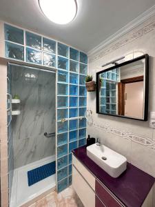 a bathroom with a shower and a sink and a mirror at Ocean Views - Beach Apartment in Patalavaca