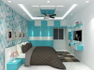 a bedroom with a bed and a ceiling fan at Aditya Tourist Home in Hampi