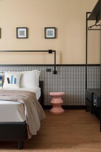 a bedroom with a bed and a black and white wall at Hotel Vagabond in Riccione