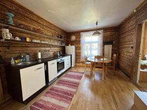a kitchen with wooden walls and a table with a sink at Treimani Country House in Treimani +33 photos