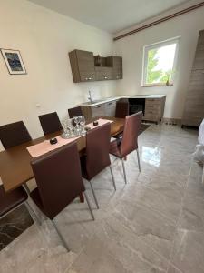 a kitchen with a table and chairs in a room at Rooms Ljubenko in Karlovac