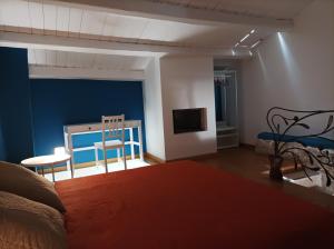 a bedroom with a bed and a table and chairs at MaGia b&b Corato in Corato