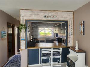 a kitchen with a bar in the middle of a room at 6 Bayview in East London