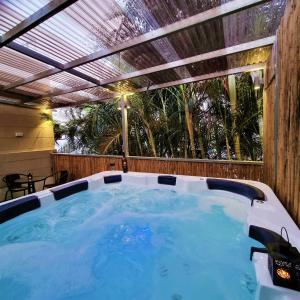 a hot tub in a backyard with a pergola at Galilee Triple Terrace in Tiberias