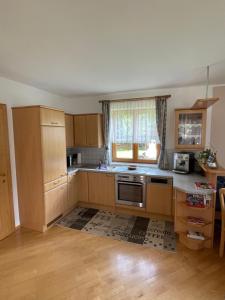 a kitchen with wooden cabinets and a stove top oven at Appartement Silvia in Oberweissburg +15 photos