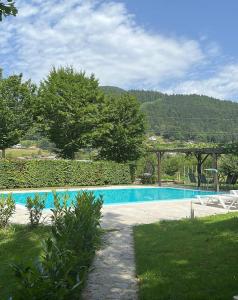 a swimming pool in a yard with chairs and trees at Glamping Laško in Laško