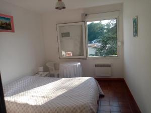 a bedroom with a bed and a window at Villa Arc en Ciel et clé des champs in Contrexéville