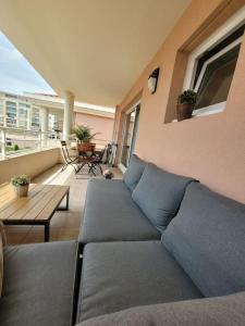 a living room with a couch on a balcony at Domaine Juan Flore in Antibes