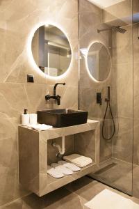 a bathroom with a sink and a shower at P J Luxury Suites in Serres